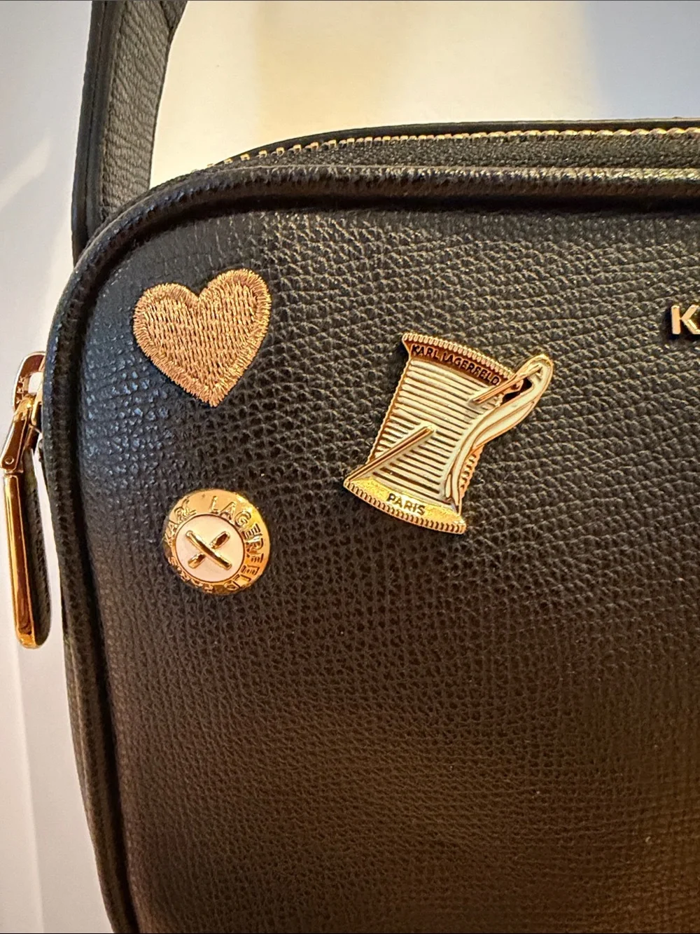 Karl Lagerfeld Black Crossbody Camera Bag with Gold & Pink Charm Accents